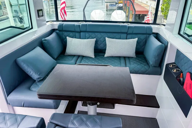 Slide: The Image of Luxurious interior of 2023 Axopar 37 XC Cross Cabin with plush seating and table. - 43
