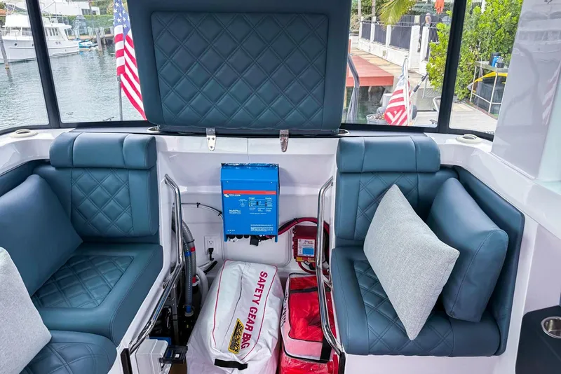 Slide: The Image of 2023 Axopar 37 XC Cross Cabin interior with blue seating and safety gear. - 44