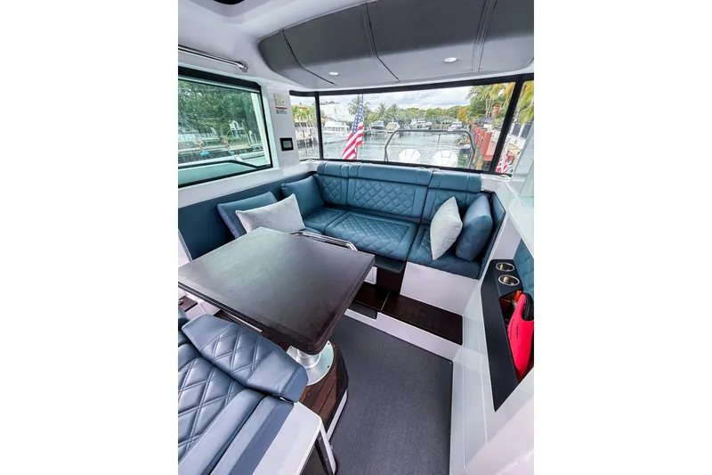 Slide: The Image of Luxurious interior of 2023 Axopar 37 XC Cross Cabin with plush seating and table. - 45