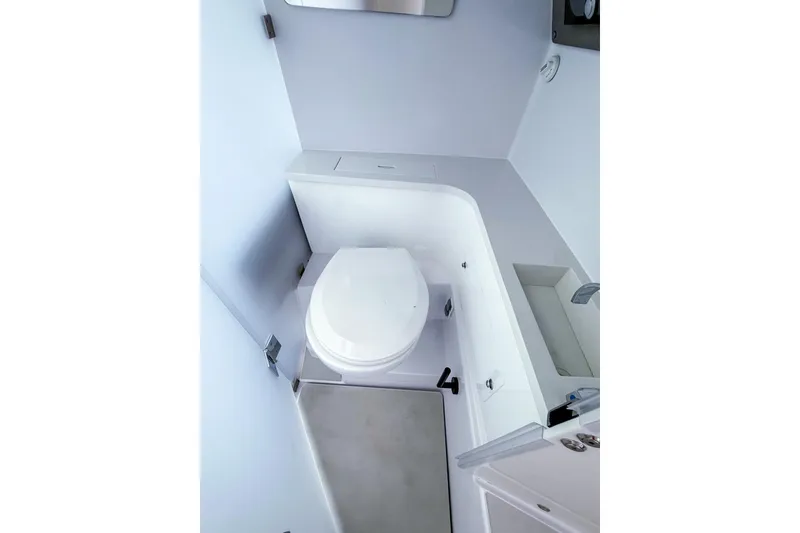 Slide: The Image of 2023 Axopar 37 XC Cross Cabin bathroom with modern white fixtures and compact design. - 49