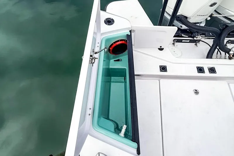 Slide: The Image of 2023 Axopar 37 XC Cross Cabin boat deck with storage compartment and engine view. - 5