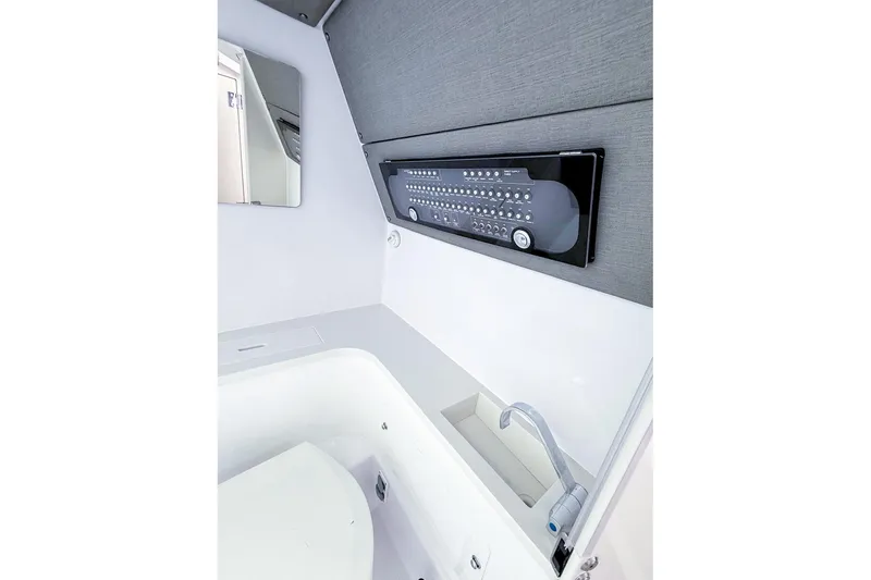 Slide: The Image of Interior of 2023 Axopar 37 XC Cross Cabin, featuring control panel and sink. - 50