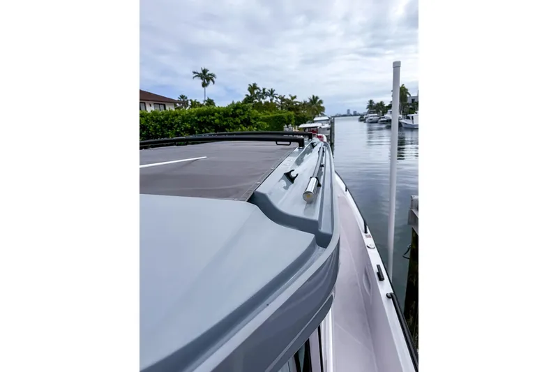 Slide: The Image of 2023 Axopar 37 XC Cross Cabin docked by a serene waterfront. - 54