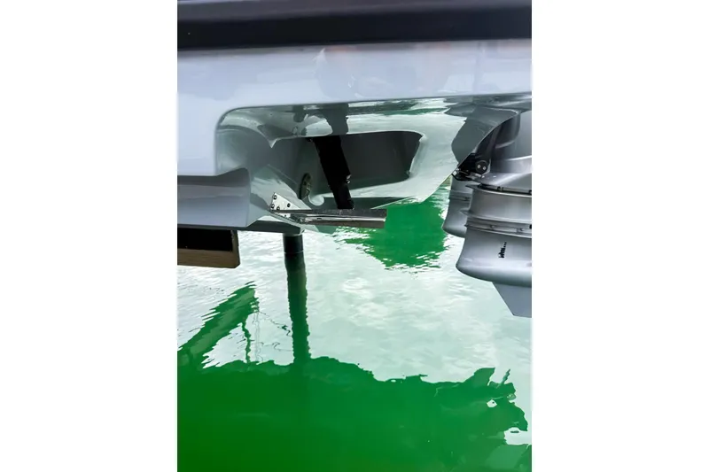 Slide: The Image of 2023 Axopar 37 XC Cross Cabin boat engine detail on green water. - 56