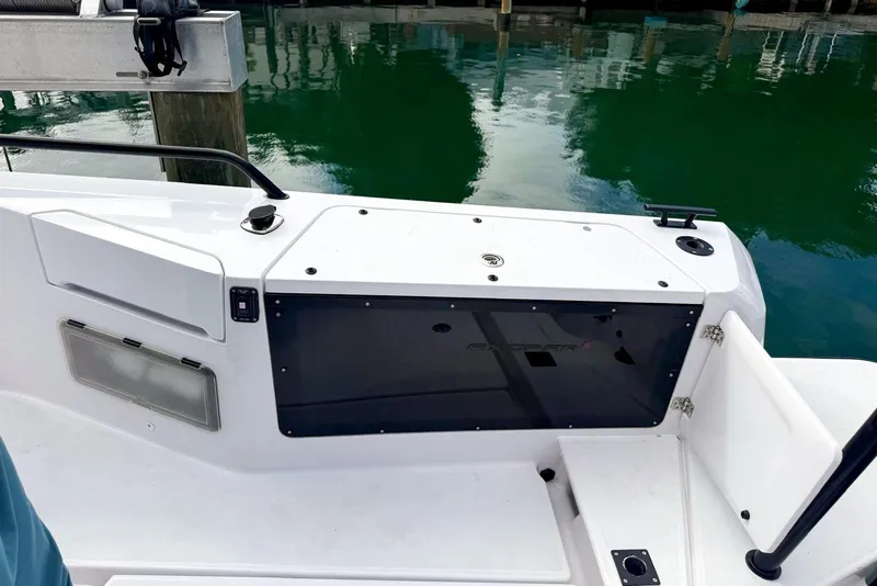 Slide: The Image of 2023 Axopar 37 XC Cross Cabin boat deck with storage compartment and railing. - 6