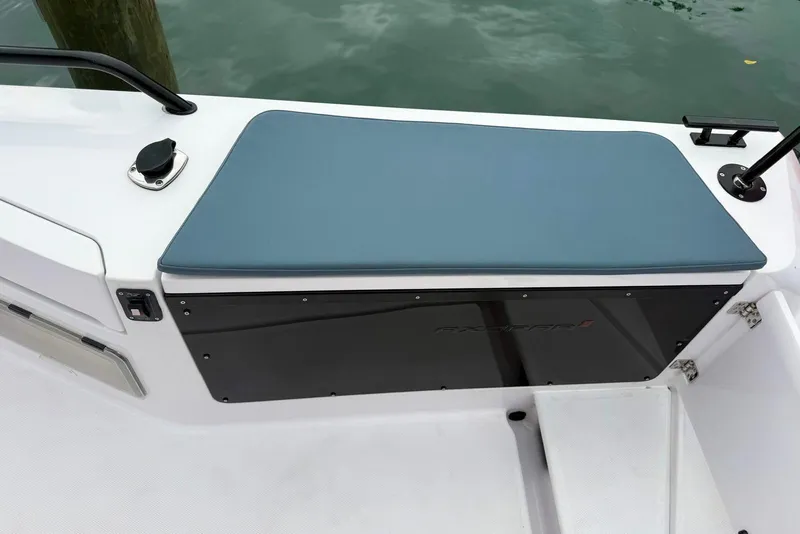 Slide: The Image of 2023 Axopar 37 XC Cross Cabin boat seating area with blue cushion and sleek design. - 7