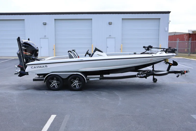 The Image of 2020 Caymas CX 20 PRO boat on trailer, parked outside industrial building. - 1