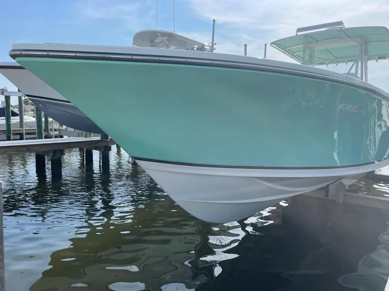 Slide: The Image of 2007 SeaCraft 32 boat docked on water. - 13