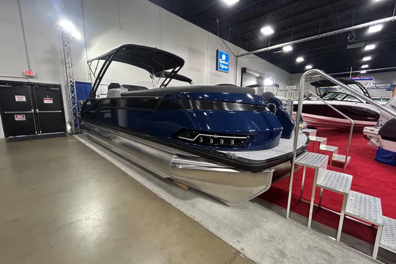 The Image of 2026 Harris Grand Mariner 250 pontoon boat displayed indoors with sleek design and modern features. - 0