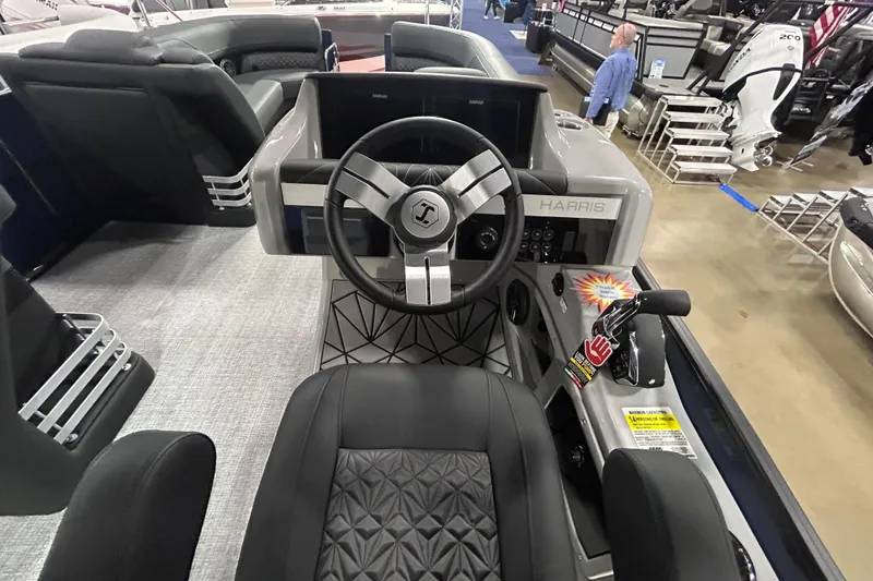 Slide: The Image of 2026 Harris Grand Mariner 250 boat interior with steering wheel and control panel. - 4