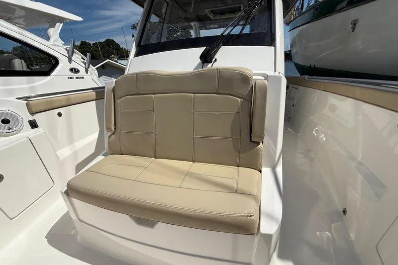 Slide: The Image of 2021 Pursuit S 328 Sport boat with beige seating and sleek interior design. - 2