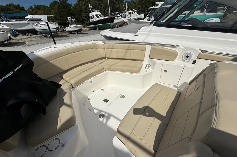 Slide: The Image of 2021 Pursuit S 328 Sport boat interior with beige seating and cup holders. - 5