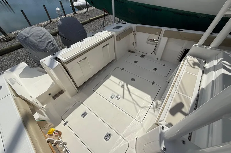 Slide: The Image of 2021 Pursuit S 328 Sport boat deck with storage compartments and seating. - 6