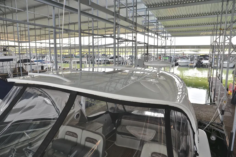 Slide: The Image of 2016 Sea Ray Sundancer 370 docked in a marina under a metal canopy. - 11