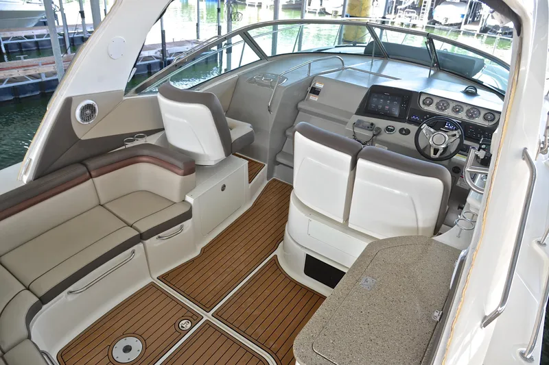Slide: The Image of 2016 Sea Ray Sundancer 370 cockpit with luxurious seating and modern dashboard controls. - 12