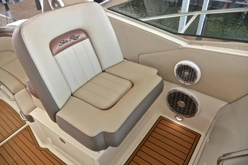 Slide: The Image of 2016 Sea Ray Sundancer 370 interior with beige seating and marine speakers. - 15