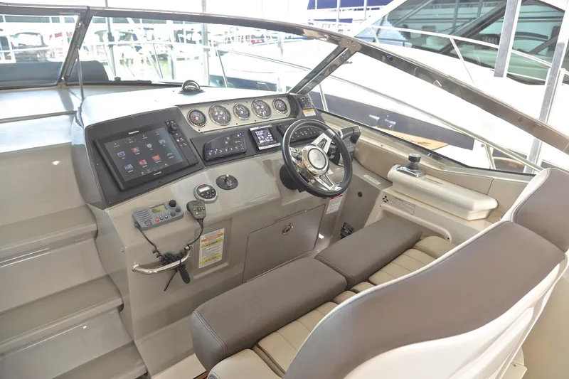 Slide: The Image of 2016 Sea Ray Sundancer 370 helm with modern controls and navigation system. - 20