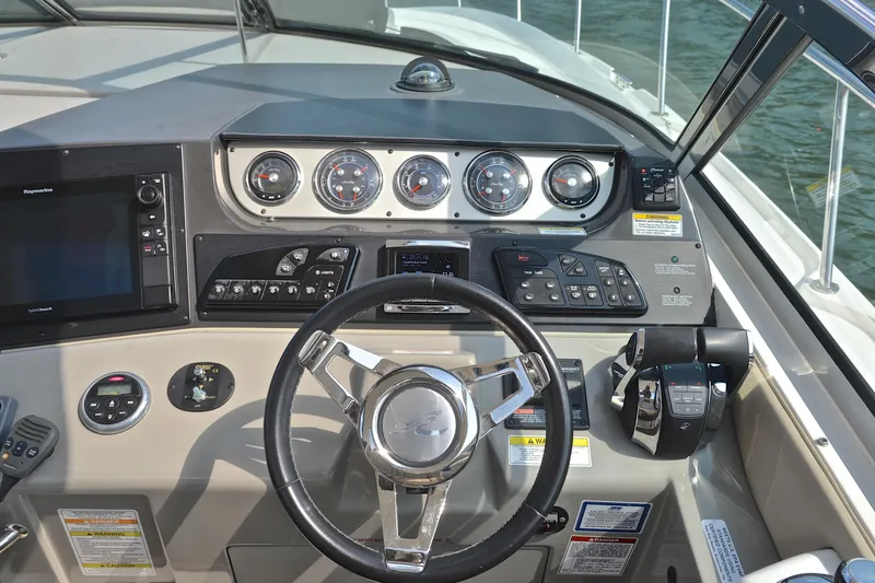 Slide: The Image of Cockpit of 2016 Sea Ray Sundancer 370 with steering wheel and control panel. - 21