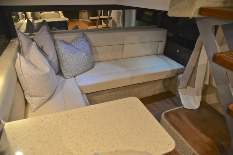 Slide: The Image of Interior of 2016 Sea Ray Sundancer 370 with cozy seating and decorative pillows. - 39