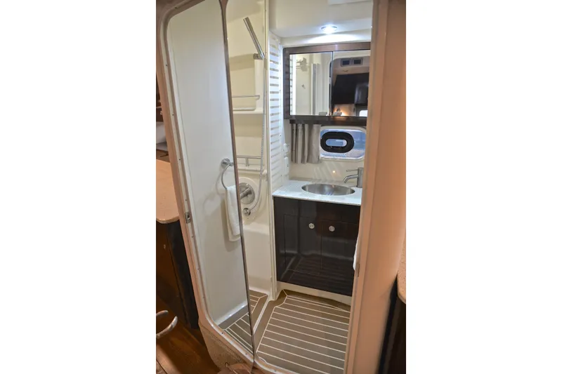 Slide: The Image of 2016 Sea Ray Sundancer 370 bathroom with shower, sink, and mirror. - 43
