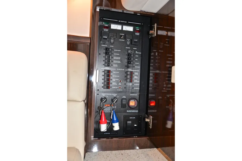 Slide: The Image of Electrical panel inside 2016 Sea Ray Sundancer 370 yacht, featuring switches and controls. - 44