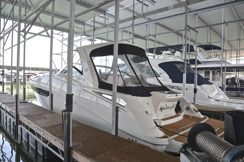 Slide: The Image of 2016 Sea Ray Sundancer 370 docked in a covered marina. - 6