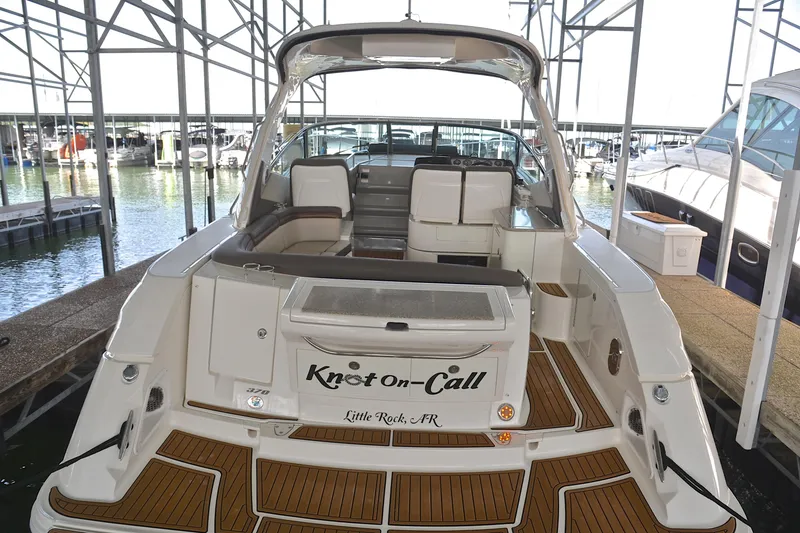 Slide: The Image of 2016 Sea Ray Sundancer 370 docked, rear view, featuring spacious seating and elegant design. - 8