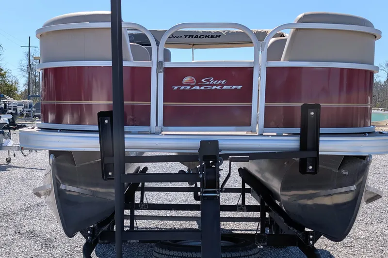 Slide: The Image of 2023 Sun Tracker Party Barge 18 pontoon boat on trailer, rear view. - 2