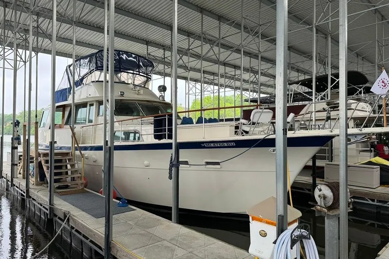 Slide: The Image of 1978 Hatteras 53 Motor Yacht docked in a covered marina. - 11