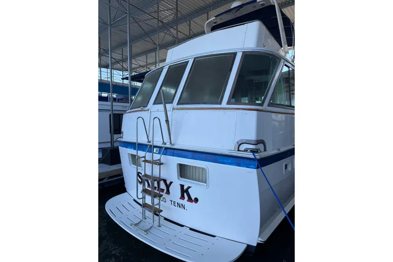 Slide: The Image of 1978 Hatteras 53 Motor Yacht docked, featuring a white exterior and blue accents. - 13