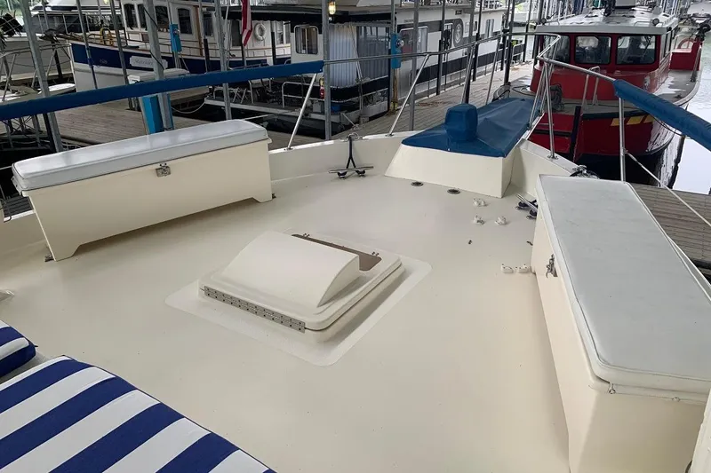 Slide: The Image of 1978 Hatteras 53 Motor Yacht deck with storage and seating, docked at marina. - 14
