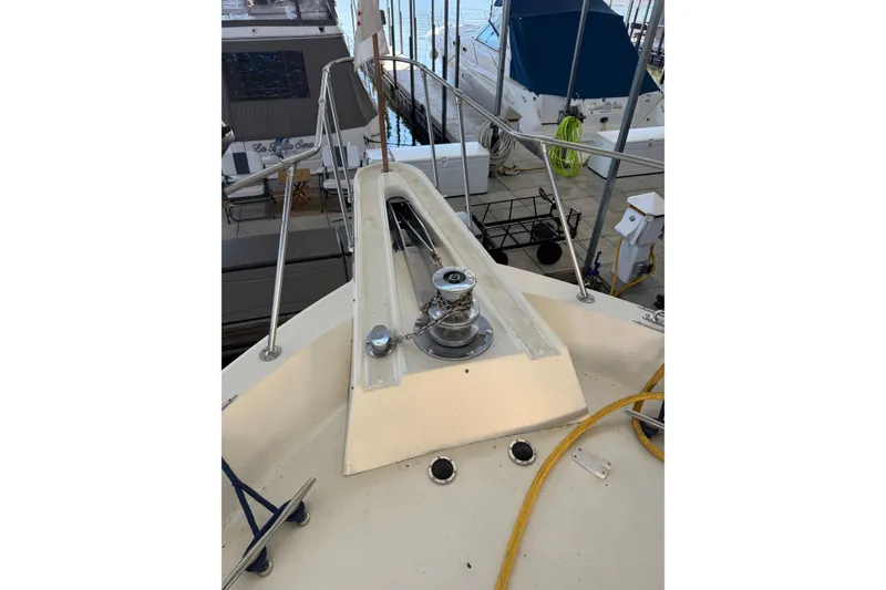 Slide: The Image of 1978 Hatteras 53 Motor Yacht bow with anchor winch and railing. - 15
