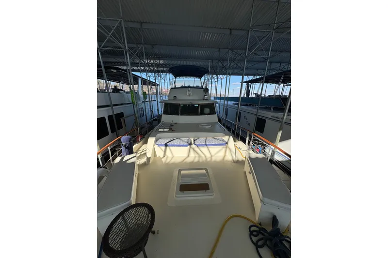 Slide: The Image of 1978 Hatteras 53 Motor Yacht docked under covered marina. - 16
