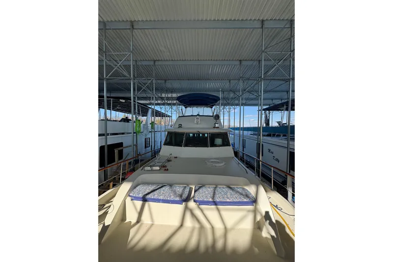 Slide: The Image of 1978 Hatteras 53 Motor Yacht docked under a covered marina. - 17