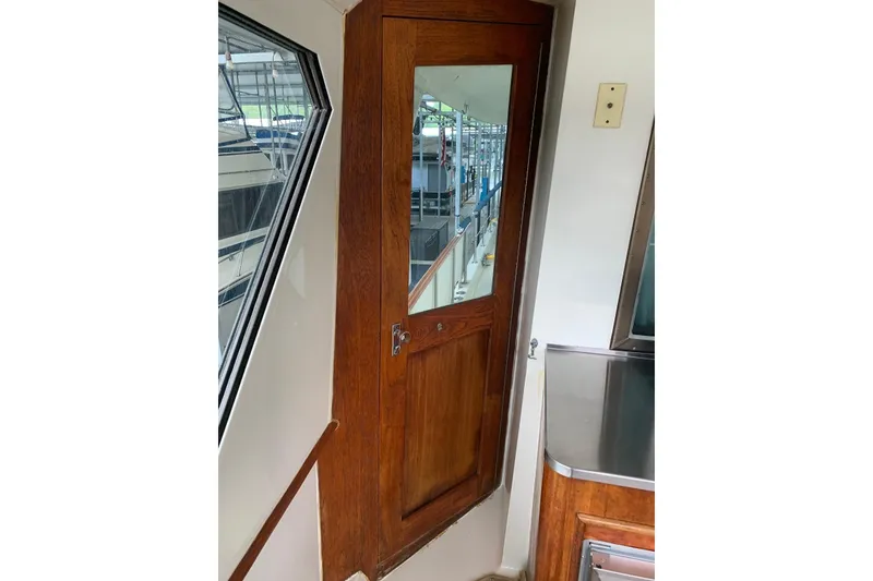 Slide: The Image of Interior view of 1978 Hatteras 53 Motor Yacht with wooden door and window. - 20