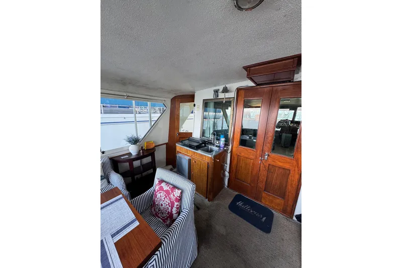 Slide: The Image of Interior of a 1978 Hatteras 53 Motor Yacht with wood accents and seating area. - 22