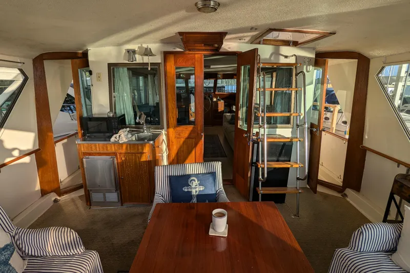 Slide: The Image of Interior of a 1978 Hatteras 53 Motor Yacht with wood accents and nautical decor. - 26