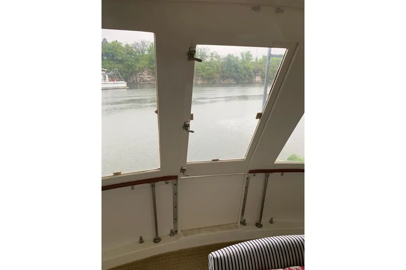 Slide: The Image of Interior view from a 1978 Hatteras 53 Motor Yacht, overlooking a serene waterway. - 27