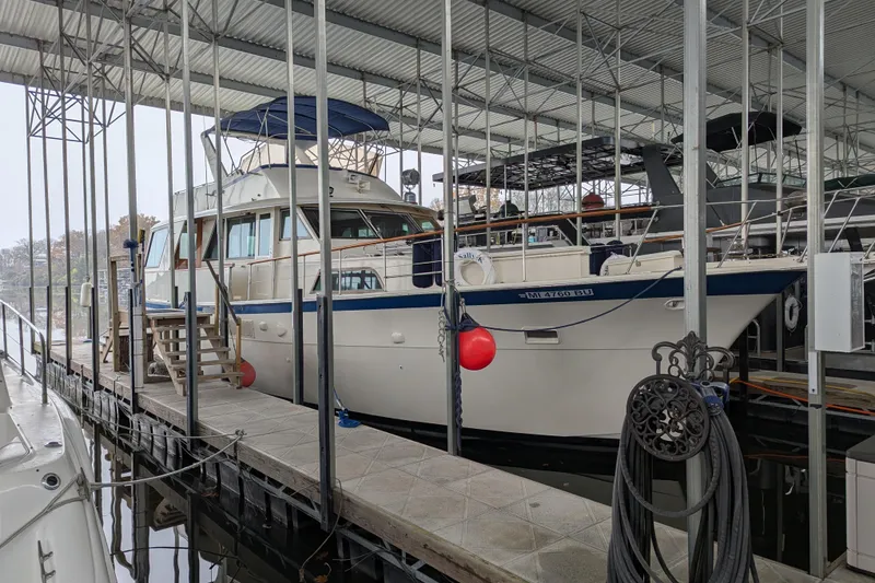 Slide: The Image of 1978 Hatteras 53 Motor Yacht docked in a covered marina. - 3