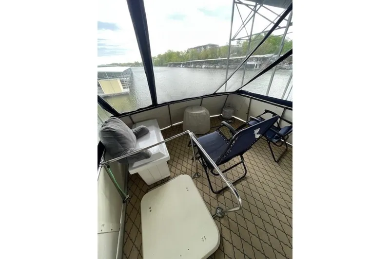 Slide: The Image of 1978 Hatteras 53 Motor Yacht deck with chairs and scenic water view. - 30