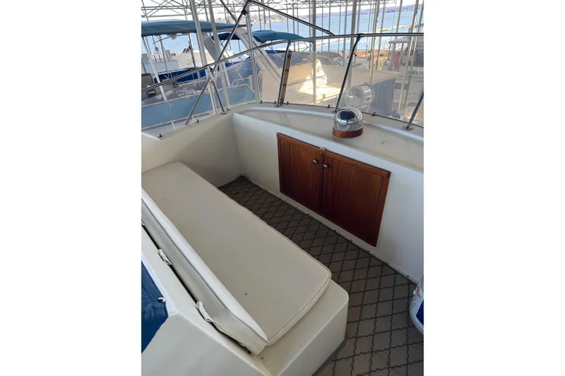 Slide: The Image of 1978 Hatteras 53 Motor Yacht interior with seating and wooden cabinet. - 32