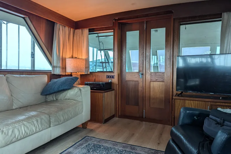 Slide: The Image of Interior of 1978 Hatteras 53 Motor Yacht with cozy seating and wooden accents. - 34