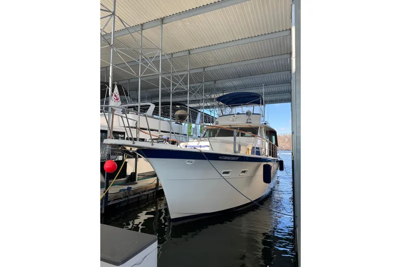 Slide: The Image of 1978 Hatteras 53 Motor Yacht docked under a covered marina. - 4