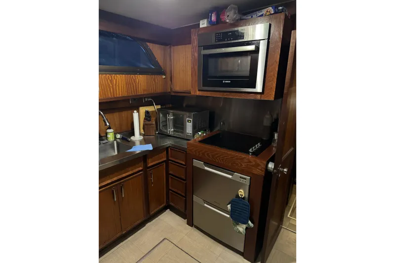 Slide: The Image of 1978 Hatteras 53 Motor Yacht kitchen with modern appliances and wooden cabinetry. - 47