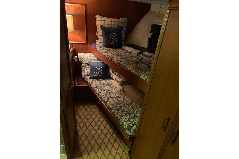 Slide: The Image of Cozy cabin with bunk beds on 1978 Hatteras 53 Motor Yacht, featuring elegant decor. - 48