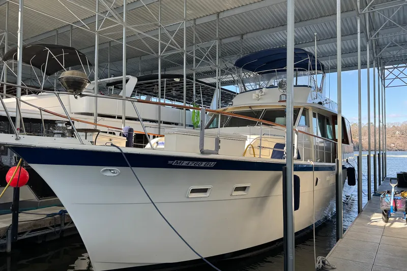 Slide: The Image of 1978 Hatteras 53 Motor Yacht docked under a covered marina. - 5