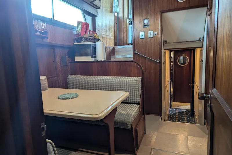 Slide: The Image of Interior of a 1978 Hatteras 53 Motor Yacht with dining area and hallway. - 51