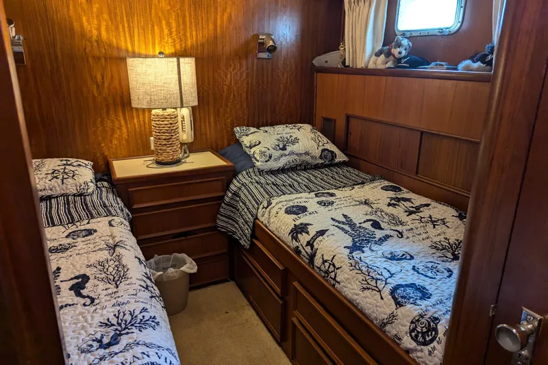 Slide: The Image of Cozy twin cabin on 1978 Hatteras 53 Motor Yacht with nautical-themed bedding. - 53