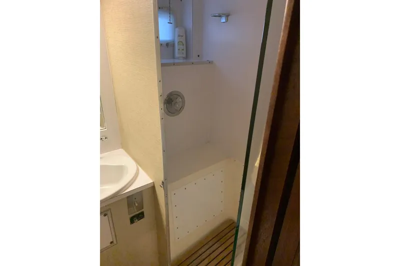 Slide: The Image of Shower area in 1978 Hatteras 53 Motor Yacht with wooden floor slats. - 54