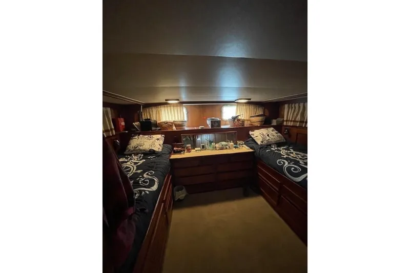 Slide: The Image of 1978 Hatteras 53 Motor Yacht cabin with twin beds and wooden interior. - 56